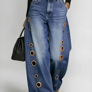Retro-style wide-leg jeans with metallic eyelets, high-waisted, loose, floor-length fit, gradient eyelets of varying sizes on both sides, distressed washed finish, classic front and back pockets, perfect for everyday casual wear.